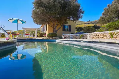 a swimming pool in front of a house at Villa Sirena - Scopello-Villas in Scopello