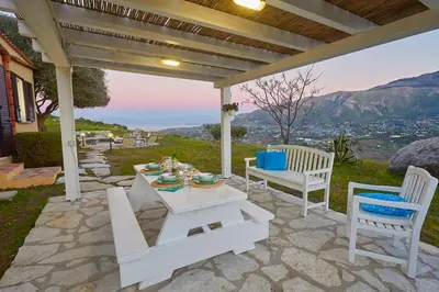 a patio with a table and chairs and a view at Villa Sirena - Scopello-Villas in Scopello