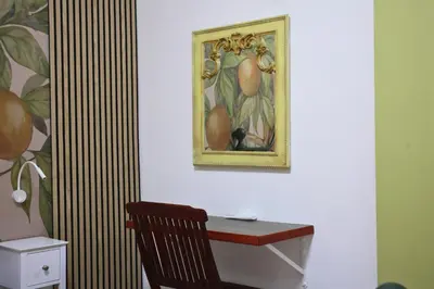 a desk with a picture of fruit on a wall at Orange Lemon Garden Palermo in Palermo