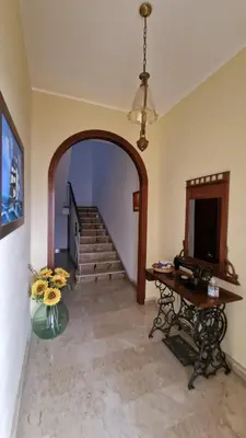 a room with a hallway with a table and stairs at Casa vacanza-Il Sole di Sicilia in Vita