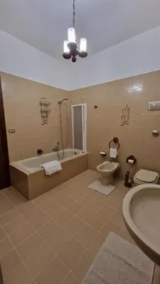 a bathroom with a tub and a toilet and a sink at Casa vacanza-Il Sole di Sicilia in Vita