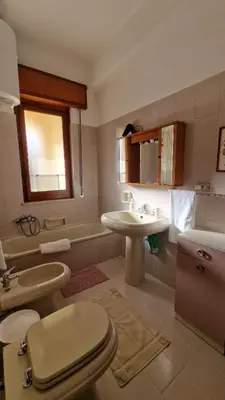 a bathroom with a toilet and a sink at Casa vacanza-Il Sole di Sicilia in Vita