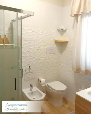 a bathroom with a toilet and a sink and a shower at Domus Amelio - Country Rooms in Cinisi