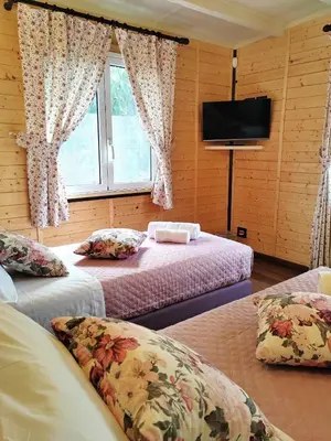 a bedroom with two beds and a flat screen tv at Domus Amelio - Country Rooms in Cinisi