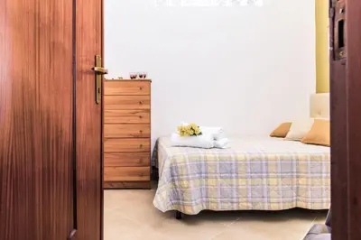 a bedroom with a bed with a stuffed animal on it at Casa Dorotea in Balestrate