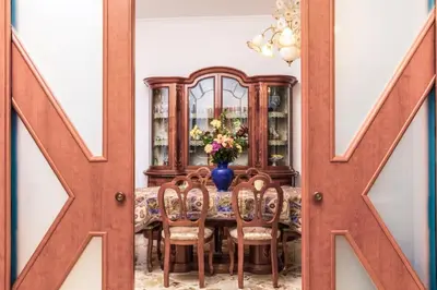 a dining room with a table with chairs and a chutch at Casa Dorotea in Balestrate