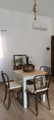 a dining room table with four chairs around it at Metro 171 Loft in Palermo