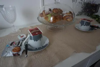 a table with a plate of pastries and a bowl of food at Bed and Breakfast Palermo Centro in Palermo