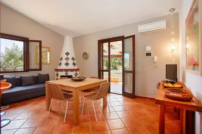 a living room with a table and a couch at Villa del Drago in Scopello
