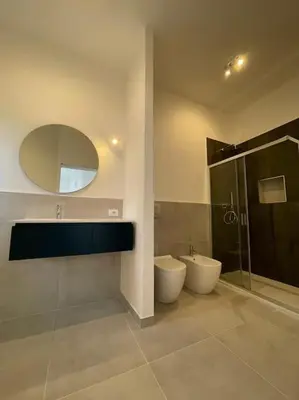 a bathroom with a toilet and a shower and a mirror at Coralìa in San Vito lo Capo