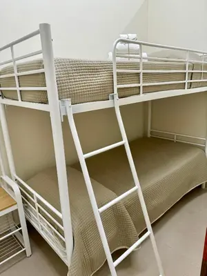 a bunk bed room with two bunk beds and a ladder at Casetta Philia - Castellammare del Golfo in Castellammare del Golfo