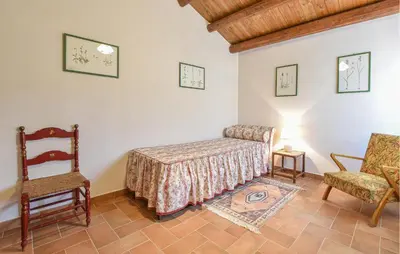 a room with a bed and a chair and a table at Pet Friendly Home In Corleone With Wifi in Corleone