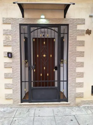 a front door of a house with a wrought iron gate at Casa Sabo Apartment in Palermo