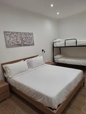 a bedroom with two beds and two bunk beds at Casa Sabo Apartment in Palermo