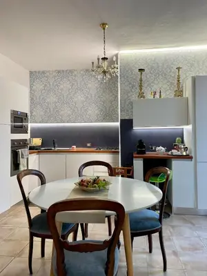 a kitchen with a white table and chairs and a table and a kitchen at Splendida Villa immersa nella natura - Villa Salina Trabia in Trabia