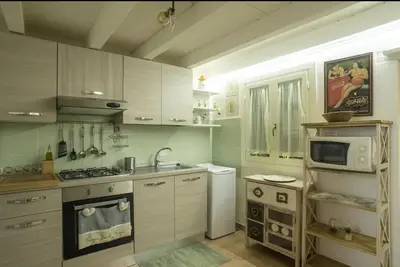 a white bathroom with a sink on a wooden table at NanaHouse Cozy apt in Corso Vittorio Emanuele in Palermo