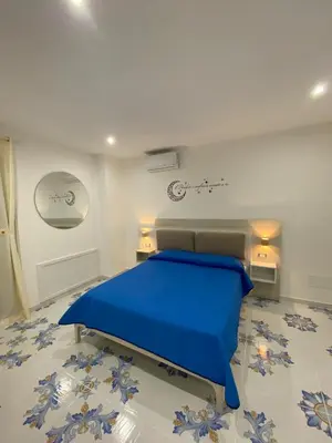 a bedroom with a blue bed in a room at Casa Vacanze dell'Arco - civico 17 in Trabia