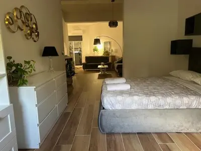 a bedroom with a bed and a living room at Francys Dreams in Palermo