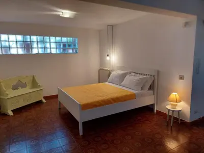a bedroom with a bed and a window at Hola House Mondello in Lido di Mondello