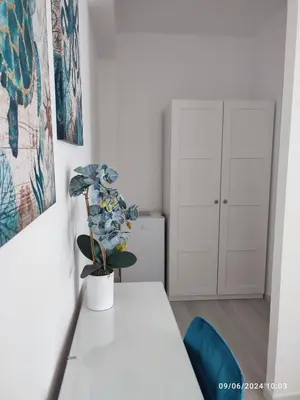 a white table in a room with a plant on it at Tramonti d'Alba in Terrasini