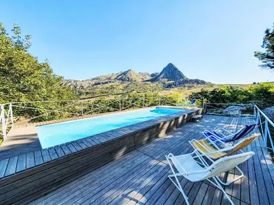 a deck with chairs and a swimming pool at Villa Ginestra by Interhome in Piana degli Albanesi