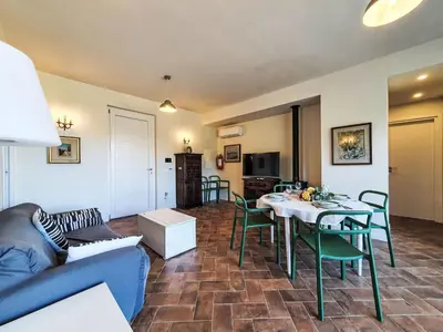 a living room with a couch and a table and chairs at Villa Ginestra by Interhome in Piana degli Albanesi