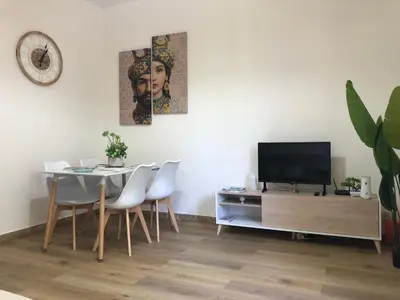 a dining room with a table and a television at Nichi & Matti Iemmolo's Guest House in Campofelice di Roccella