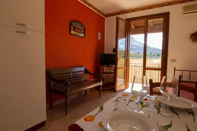 a dining room with a table with wine glasses at Residence Hotel Marino Tourist in San Vito lo Capo