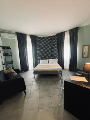 a bedroom with a bed in the middle of a room at La Terrazza su Palermo in Palermo