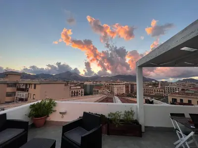 a view from the balcony of a building with a sunset at La Terrazza su Palermo in Palermo