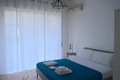 a bedroom with a bed with towels on it at Casa Amari Bd in Palermo