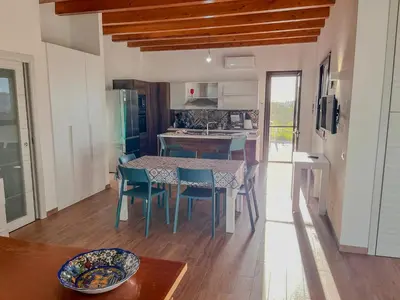 a kitchen and dining room with a table and chairs at Villa Ginevra in Santa Ninfa