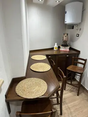 a kitchen with a table and chairs and a counter at Lucky House in Palermo