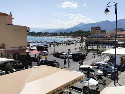 a town with cars parked in a parking lot at Appartamento Tirreno Mondello in Palermo