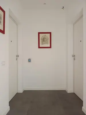 a white room with two doors and a picture on the wall at Al Duca appartamento in centro in Palermo