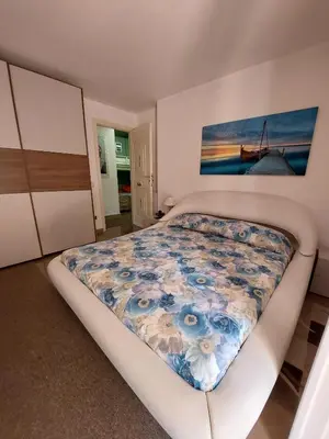 a bedroom with a bed and a painting on the wall at Oasis Green Villa in Palermo
