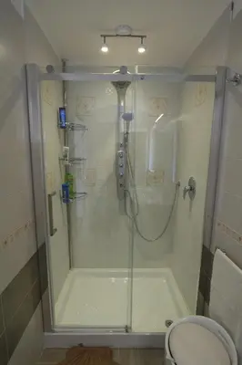 a shower stall in a bathroom with a toilet at Oasis Green Villa in Palermo