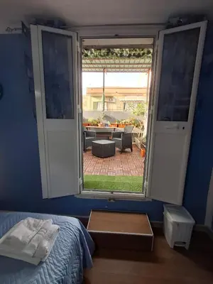 a bedroom with a window with a view of a patio at La Casa di Giovy in Palermo