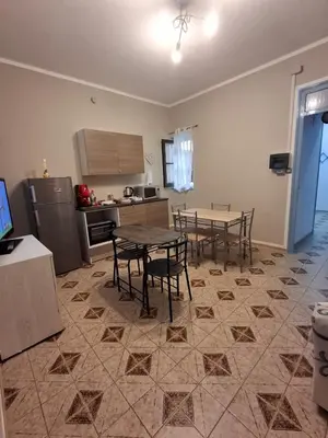 a kitchen with a table and chairs in a room at La Casa di Giovy in Palermo