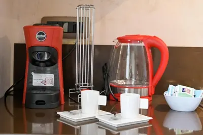 a red blender and cups on a table at Modern apartment center Palermo in Palermo