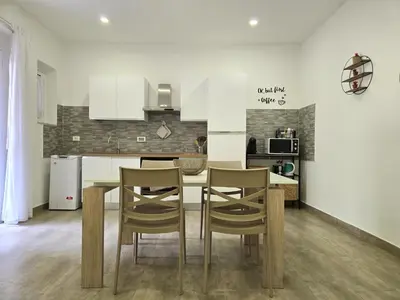 a kitchen with a table and chairs in a room at Maison Zisa - Proppro SRL - Palermo in Palermo