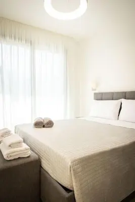 a bedroom with a large bed with two slippers on it at Luxury Villa Leto in Palermo