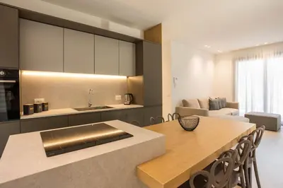 a kitchen with a table and a living room at Luxury Villa Artemis Mondello in Palermo