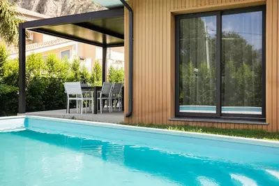 a house with a swimming pool and a patio with a table and chairs at Luxury Jacuzzi Villa Diana in Palermo