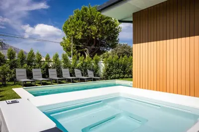 a swimming pool in the backyard of a house at Luxury Jacuzzi Villa Atena in Palermo