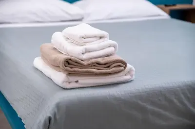 a pile of towels are stacked on a bed at Villa Luxury Eden di Sofia in Partinico