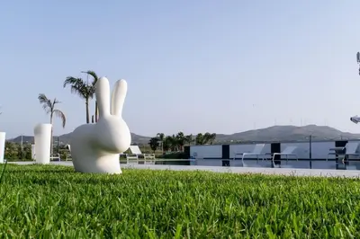 a sculpture of a rabbit sitting in the grass at Villa Luxury Eden di Sofia in Partinico