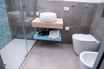 a bathroom with a toilet and a sink and a shower at Villa Luxury Eden di Sofia in Partinico