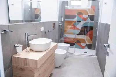 a bathroom with a sink and a toilet and a shower at Villa Luxury Eden di Sofia in Partinico