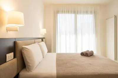 a bedroom with a bed with a pillow and a window at Luxury Jacuzzi Villa Nettuno in Palermo